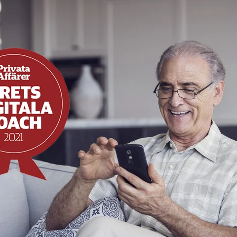 man sitting in sofa looking at phone