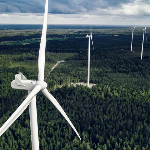 Aerial-view-of-windmills-in-summer-forest-in-Finland