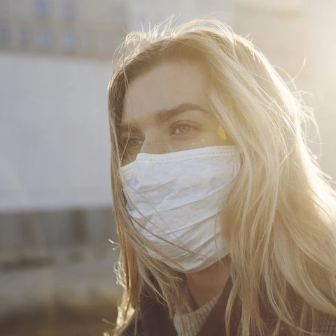 Young woman outside wearing a virus protective face