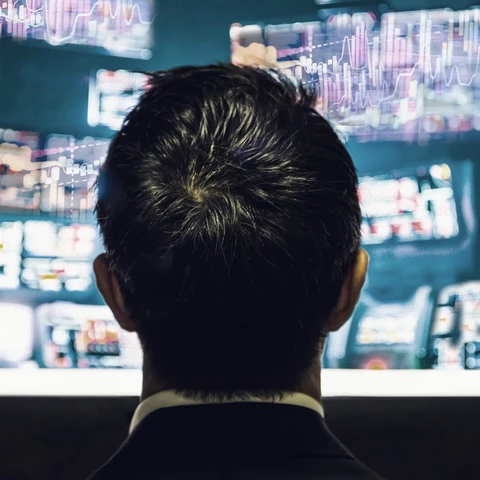 businessman-trader-looking-at-monitor-with-stock-exchange-graph