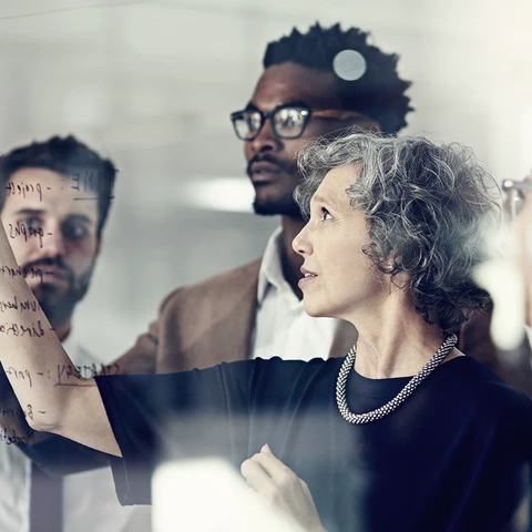 Colleagues-in-front-of-glass-wall_1920x1080