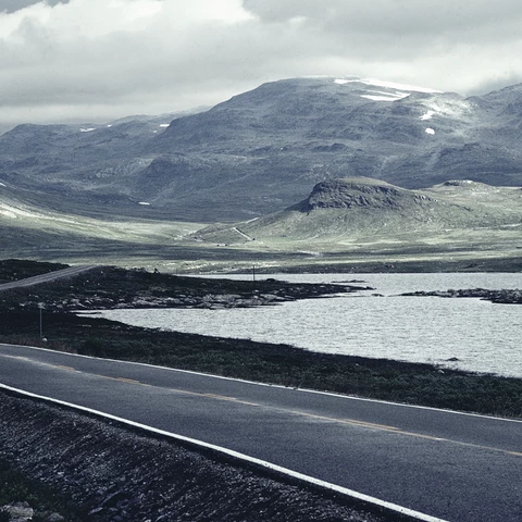 Road-next-to-sea-and-mountains