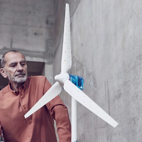 Senior man looking at prototype of wind turbine 
