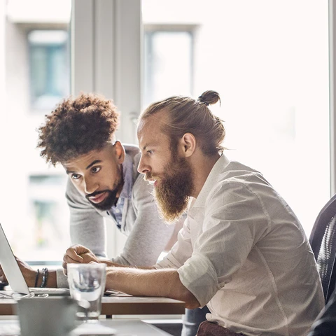 Developers discussing over laptop in office