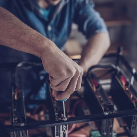 Guy configures the computer for mining cryptocurrency