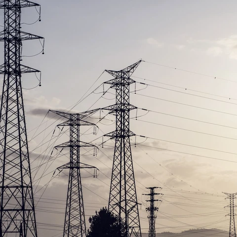 Silhouettes of a group of high-voltage electric towers