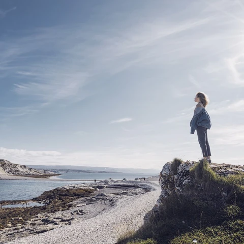 Woman standing at the coast