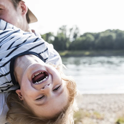 Father playing with laughing child