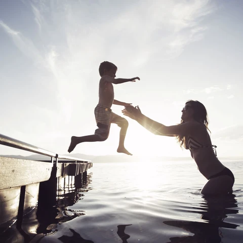Mother and son playing in lake