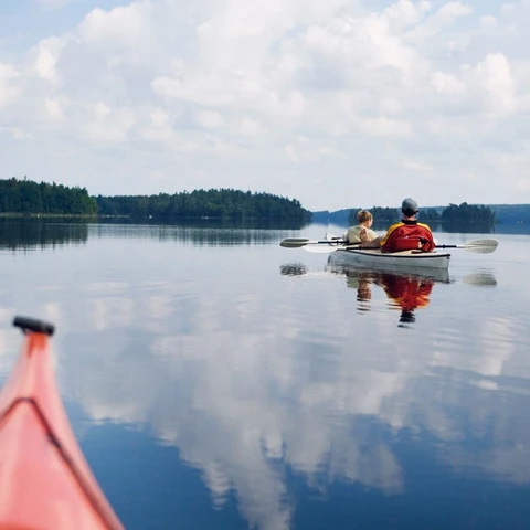 Family on canoes in lake 