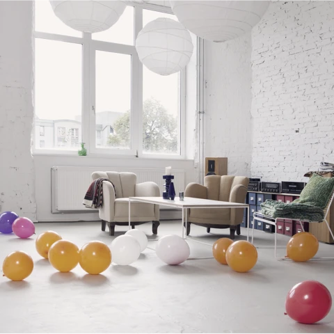 An empty room with balloons on the floor
