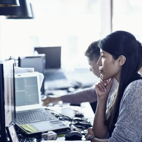 People sitting in front of computers, working in a modern office