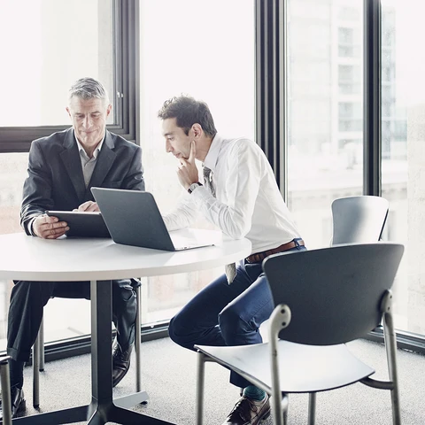 Businessmen reviewing data on digital tablet