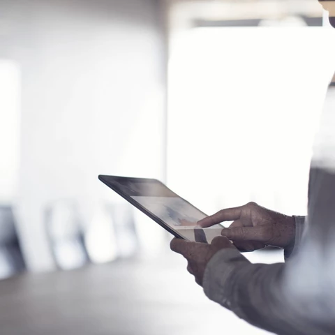 Businessman using tablet in conference room