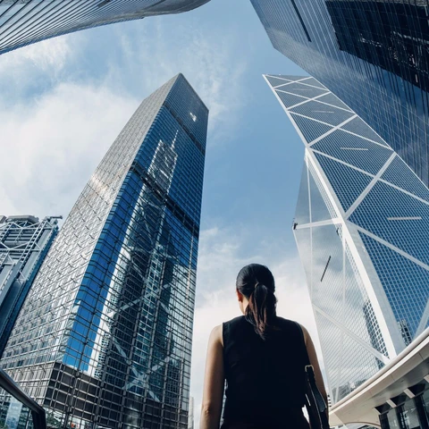 Businesswoman standing against contemporary financial skyscrapers