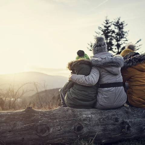 family sitting outdoors winter