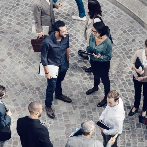 Male and female colleagues standing outdoors