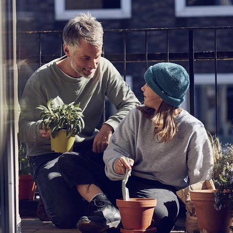 Father and daughter planting flowers
