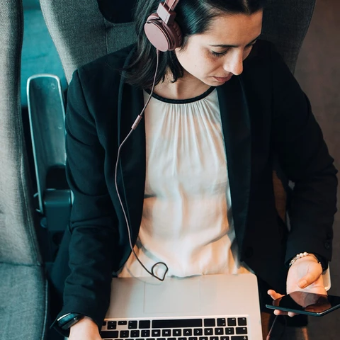 women-sitting-on-train-checking-her-phone.jpg