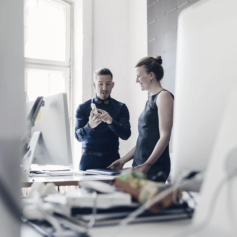 person-showing-phone-to-another-person-in-an-office.jpg