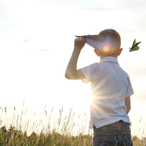 kids playing in a field in summer 