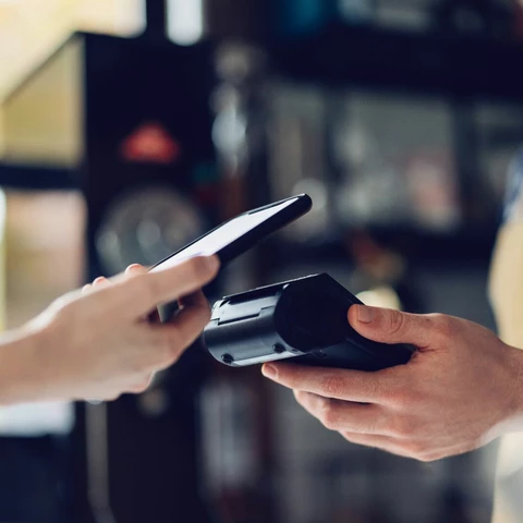 Person paying with cell phone