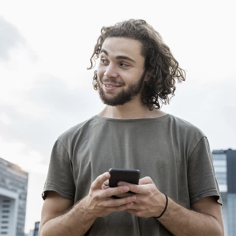 man-holding-phone-smiling