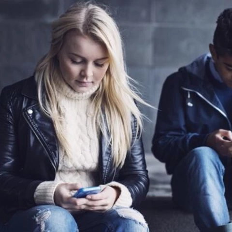 Two people using mobile phones