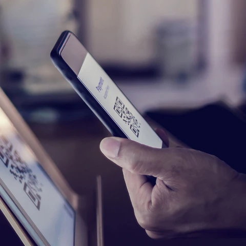 Customer using smart phone to scan QR code