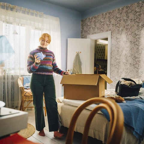 Girl in teenage room moving out