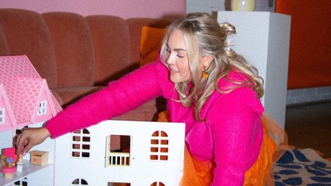 Person playing with a dollhouse