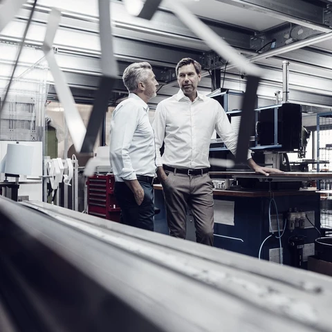 Business people planning while standing at industry