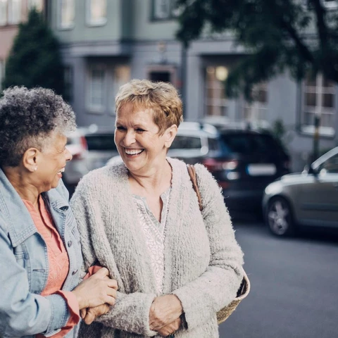 cheerful-female-friends-talking-in-city.jpg