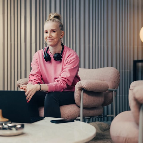 Women smiling and sitting with laptop at the office