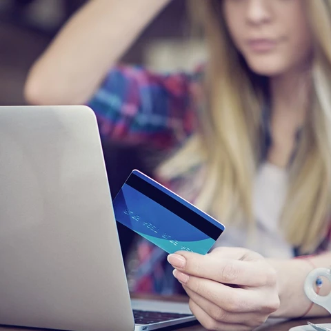 Young girl is shopping online using her credit card