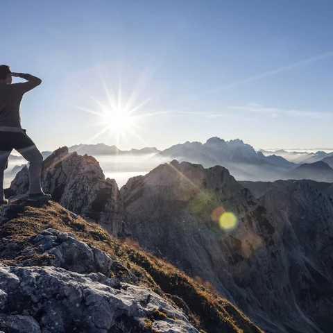 Climber standing on a mountain peak