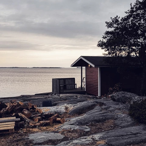 House or sauna by sea against sky