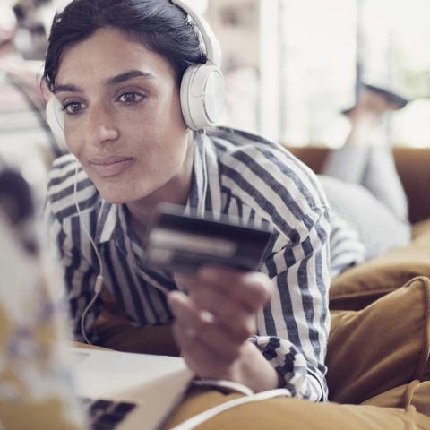 Woman online shopping from her sofa