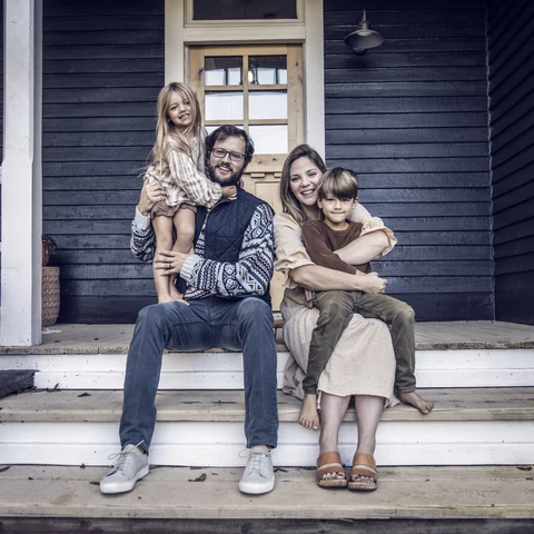 happy family sitting on the porch