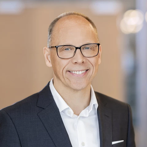 man with glasses looks into the camera