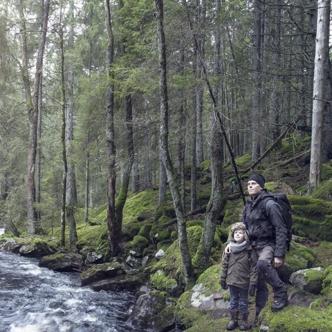 Boy with father in forest