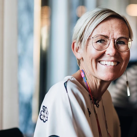 Senior smiling business woman in cafe