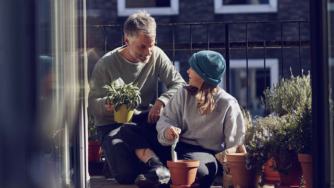 Father and daughter planting flowers