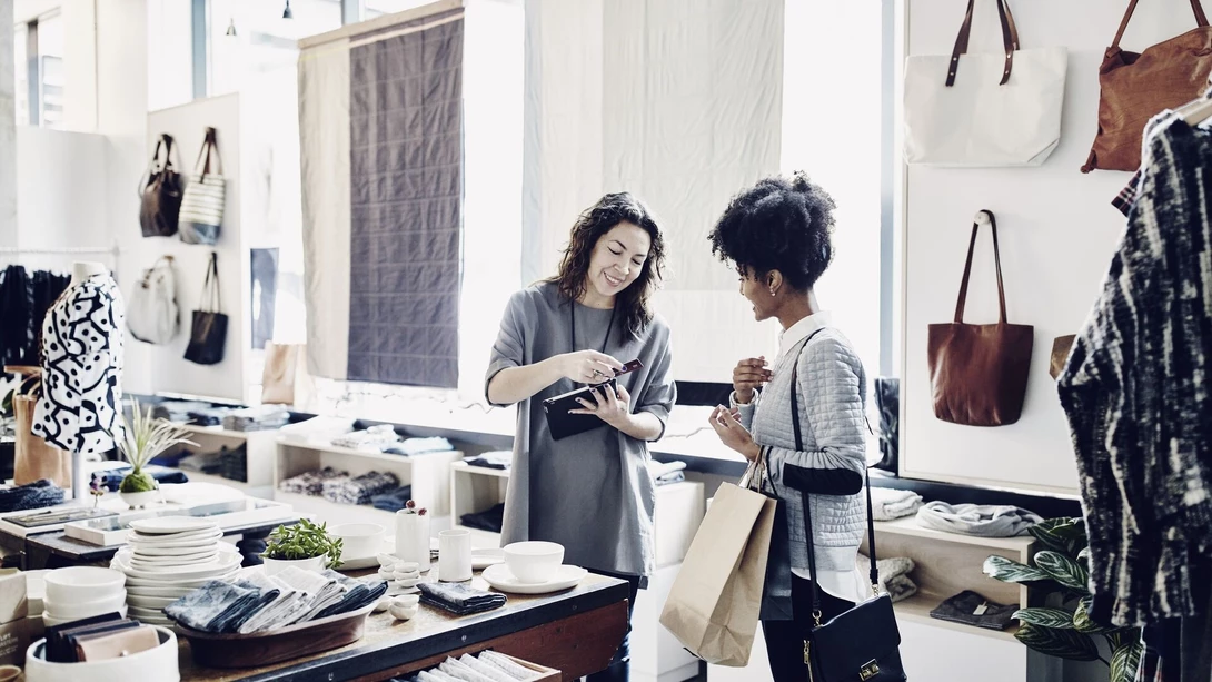 Two people processing payment in shop