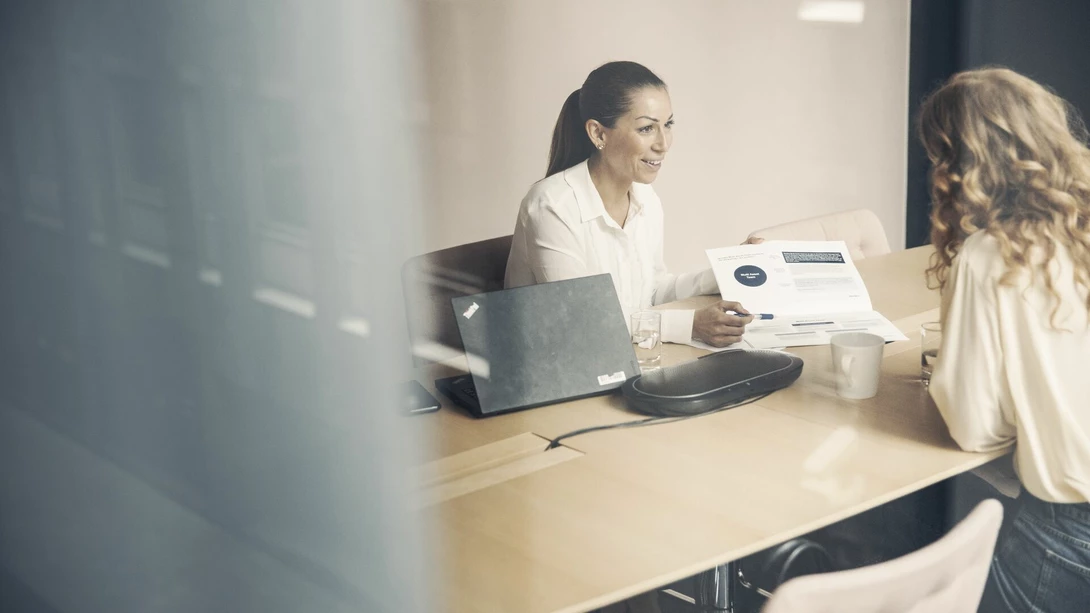 Two people in a meeting at an office
