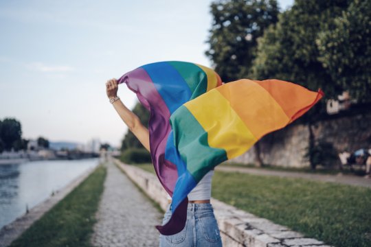 young woman with rainbow flag